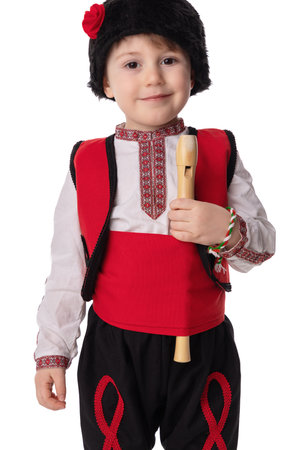 Bulgarian boy in traditional folklore costumes with spring flowers snowdrop and handcraft wool bracelet martenitsa symbol of Baba Martaの写真素材
