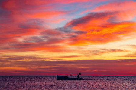 Boat and sunrise, beautiful cloudscapeの写真素材