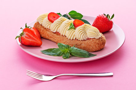 French eclair grazed with chocolate and fruity strawberry cream or sweet Italian profiteroles and...