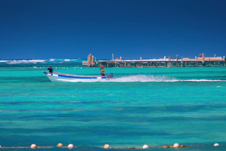Speed boat surfing over the clear water of caribbean sea, summer tropical vacationの写真素材