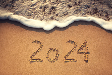 Happy New Year 2024 concept, lettering on the beach. Sea sunrise.の写真素材