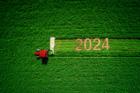 Tractor mowing green field, aerial view, happy new year 2024 concept, bio agricultureの写真素材