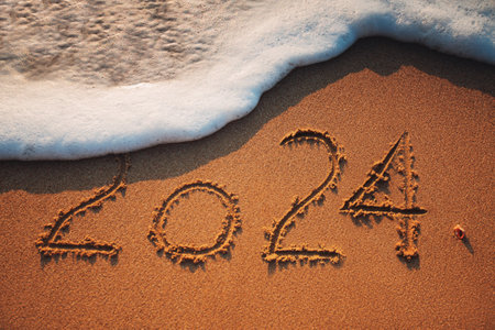 Happy New Year 2024 concept, lettering on the beach. Sea sunrise.の写真素材