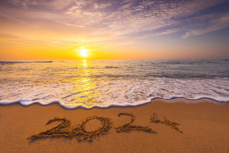 Happy New Year 2024 concept, lettering on the beach. Written text on the sea beach at sunrise.の写真素材