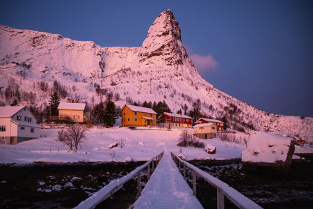 Pointed mountain of Reine with footbridge and rorbu houses in winter sunset landscape , Reine village, Lofoten islands, Nordland, Arctic, Norway, Europeの写真素材