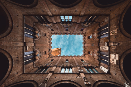 Wide angle view of famous Torre del Mangia at Palazzo Pubblico in Siena, Tuscany, Italy