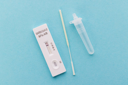 Rapid Testing Kit for SARS-CoV-2 and Flu on Light Blue Surface