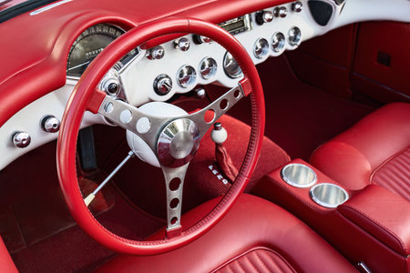 Vintage Red Sportscar Interior with Polished Dashboard and Steering Wheel Design