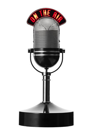A vintage silver microphone on a stand isolated on white background. Perfect for radio, podcasting, voiceovers, and broadcasting projects with a professional, retro feel.の写真素材