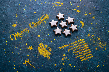 Christmas gingerbread cookies with icing biscuits stars over seasonal holiday background