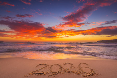 Happy New Year 2026 concept, lettering on the beach. Written text on the sea beach at sunrise.の写真素材