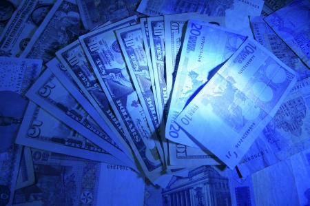 Banknotes spread out like a fan in the blue lightの写真素材