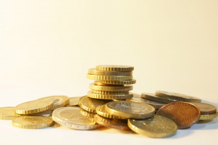 Euro coins in the pile on a white backgroundの写真素材