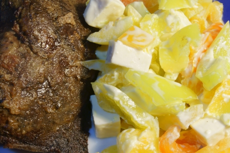 Fried liver and salad vegetables and feta cheeseの写真素材