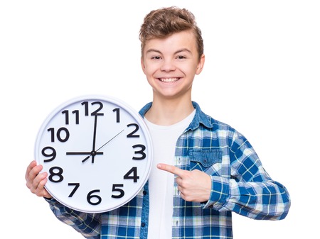 Teen boy with big clockの写真素材