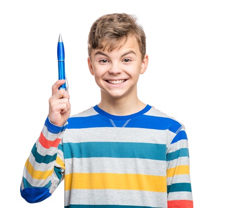 Portrait of caucasian smiling teen boy with blue pen. Handsome funny teenager looking at camera, isolated on white background.の写真素材