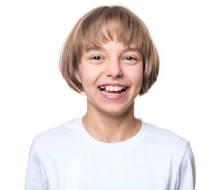 Close-up emotional portrait of attractive caucasian smiling child, isolated on a white background. Cheerful cute little girl in white blank t-shirt - fashion or advertisement design concept.の写真素材