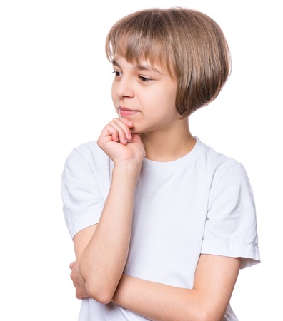 Casual thinking girl - caucasian female model. Close-up emotional portrait of child. Thoughtful kid in white t-shirt, isolated on white background. Beautiful smart serious ponder children.の写真素材