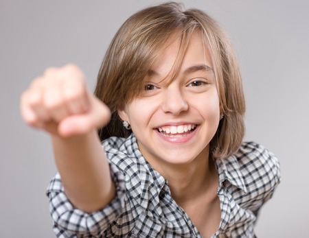 Close-up emotional portrait of caucasian little girl plays superhero. Funny super girl -
 power concept, on gray background.の写真素材