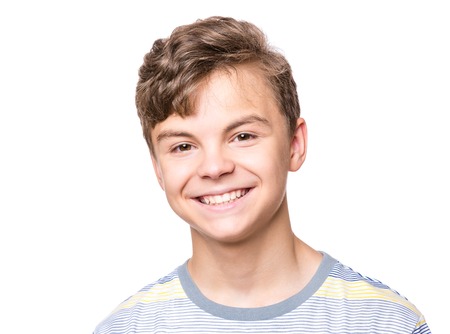 Portrait of smiling teen boy. Teenager wearing t-shirt looking at camera. Happy cute child isolated...