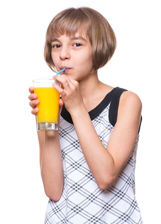 Beautiful caucasian Little Girl Drinking fresh Orange Juice. Emotional portrait of attractive Happy Child with Glass, isolated on white background.の写真素材