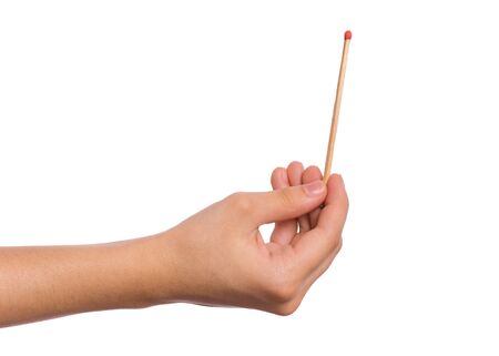 Hand of child with match, isolated on white background. Children playing with fire at home. Fire...