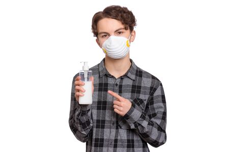 Concept of coronavirus quarantine. Child wearing medical protective mask with antibacterial antiseptic soap for hands disinfection during flu virus outbreak. COVID-19. Teen Boy isolated on white.の写真素材