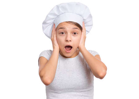 Teen girl in chef hat with emotions showing signs with hands, isolated on a white background.の写真素材