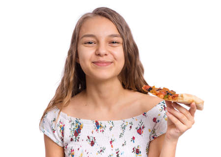 Happy beautiful young teen girl holds slice of pizza, isolated on white backgroundの写真素材