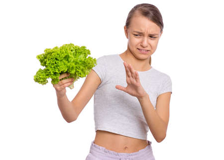Beautiful young teen girl holding holding green salad, isolated on white backgroundの写真素材