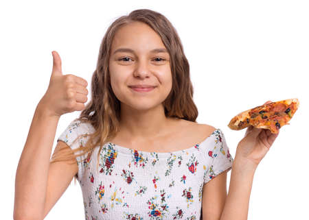 Happy beautiful young teen girl holds slice of pizza and making thumb up gestureの写真素材