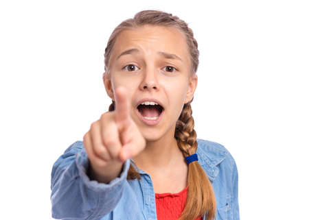 Happy teenage girl pointing up, gesturing idea or doing number one gesture, isolated on white backgroundの写真素材