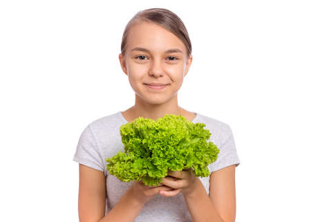 Beautiful young teen girl holding holding green salad, isolated on white backgroundの写真素材