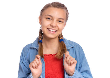 Happy teenage girl laughing looking very happy, isolated on white backgroundの写真素材