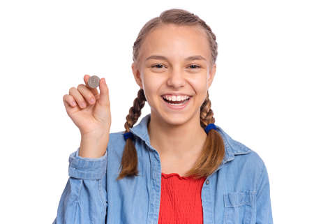 Happy teenage girl holding coin, isolated on white backgroundの写真素材