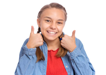 Happy teenage girl pointing up, gesturing idea or doing number one gesture, isolated on white backgroundの写真素材