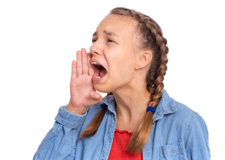 Beautiful teenage girl scream, covering her mouth with a palm, isolated on white backgroundの写真素材