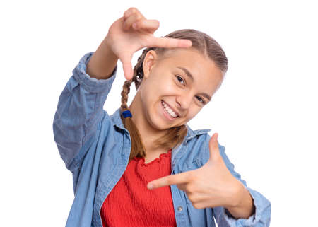 Handsome teen girl making square with his fingers, looking at camera and pleasantly smilingの写真素材