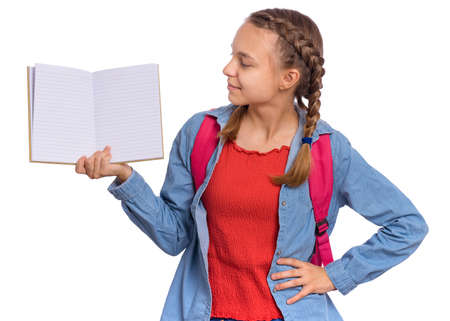 Beautiful teenage girl holds a exercise book in her hands, isolated on white backgroundの写真素材