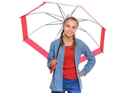 Beautiful teenage girl holding umbrella in hands, isolated on white backgroundの写真素材