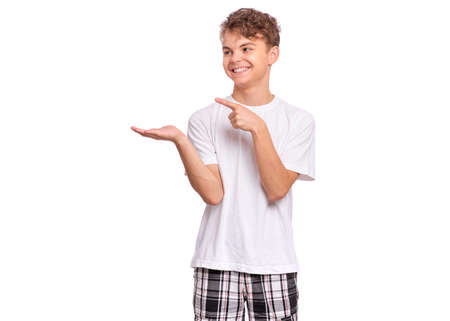 Cute teen boy pointing up, gesturing idea or doing number one gesture, isolated on white backgroundの写真素材