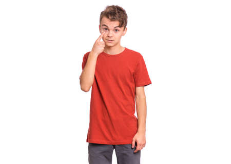 Handsome teen boy showing his eye, isolated on white backgroundの写真素材