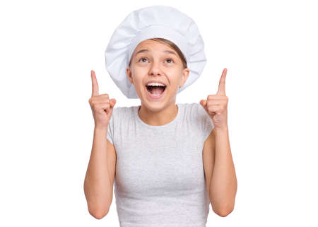 Happy teenage girl wearing chef hat with emotions showing signs with hands, isolated on a white background.の写真素材