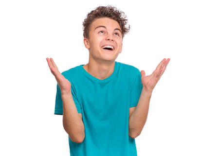 Handsome teen boy laughing looking very happy, isolated on white backgroundの写真素材