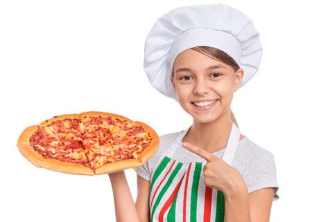 Girl cook in apron holds plate with fresh pizza, isolated on white background.の写真素材