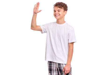 Handsome teen boy stretching his right hand up for greeting, isolated on white backgroundの写真素材