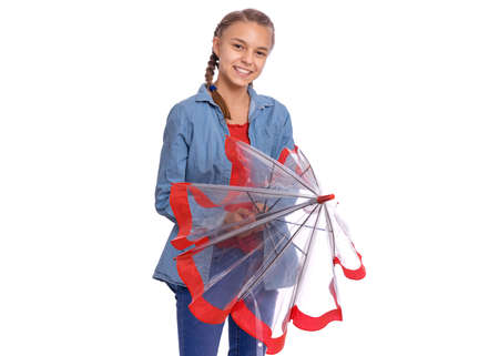 Beautiful teenage girl holding umbrella in hands, isolated on white backgroundの写真素材