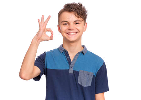 Handsome teen boy laughing looking very happy, isolated on white background.の写真素材