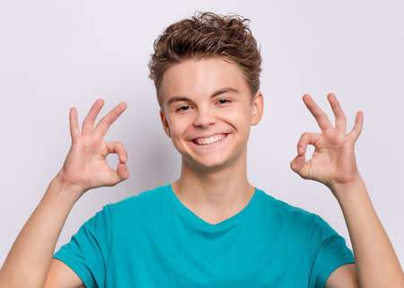 Handsome teen boy laughing looking very happy.の写真素材