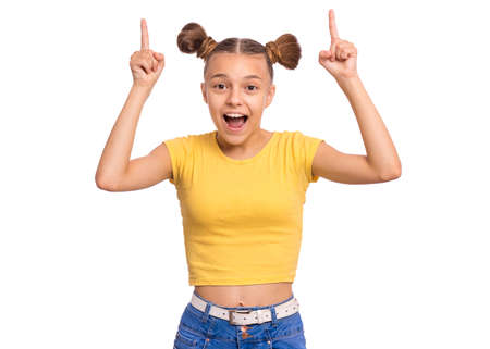 Portrait of smiling teen girl pointing a great idea, isolated on white background. Awesome idea. Beautiful young teenager keeping finger up, looking at camera. Happy cute child have unexpected ideaの写真素材